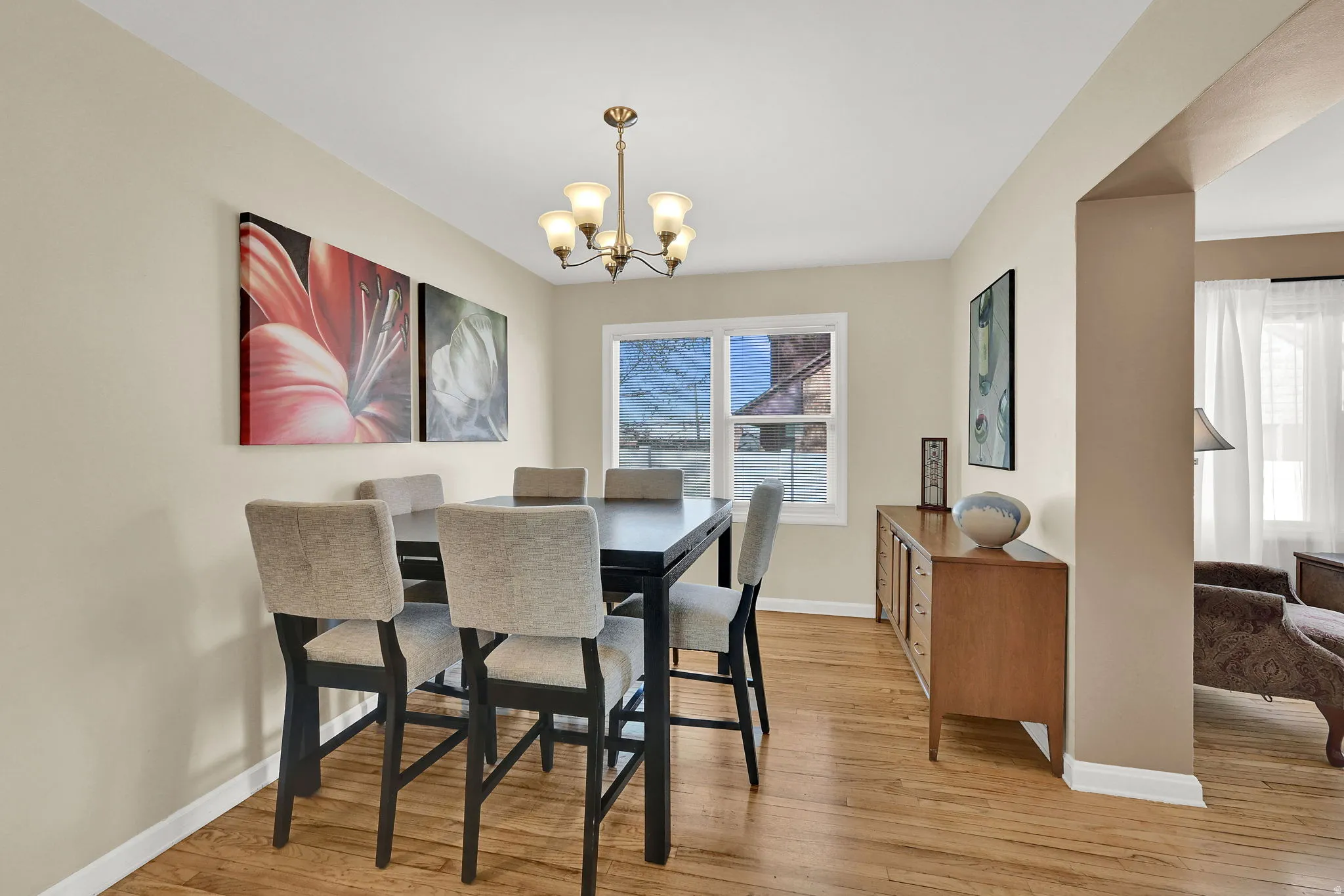 Semi-formal dining space featuring wood flooring and a chandelier