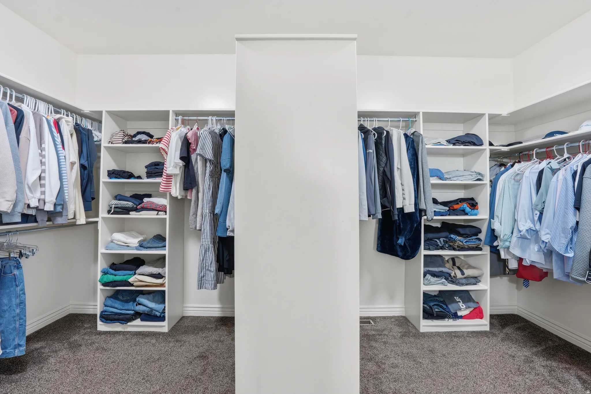 Walk in closet with dark carpet