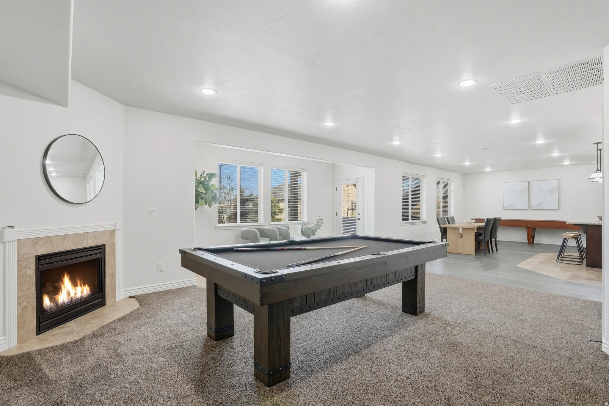Playroom featuring carpet flooring, pool table, a tiled fireplace, and recessed lighting