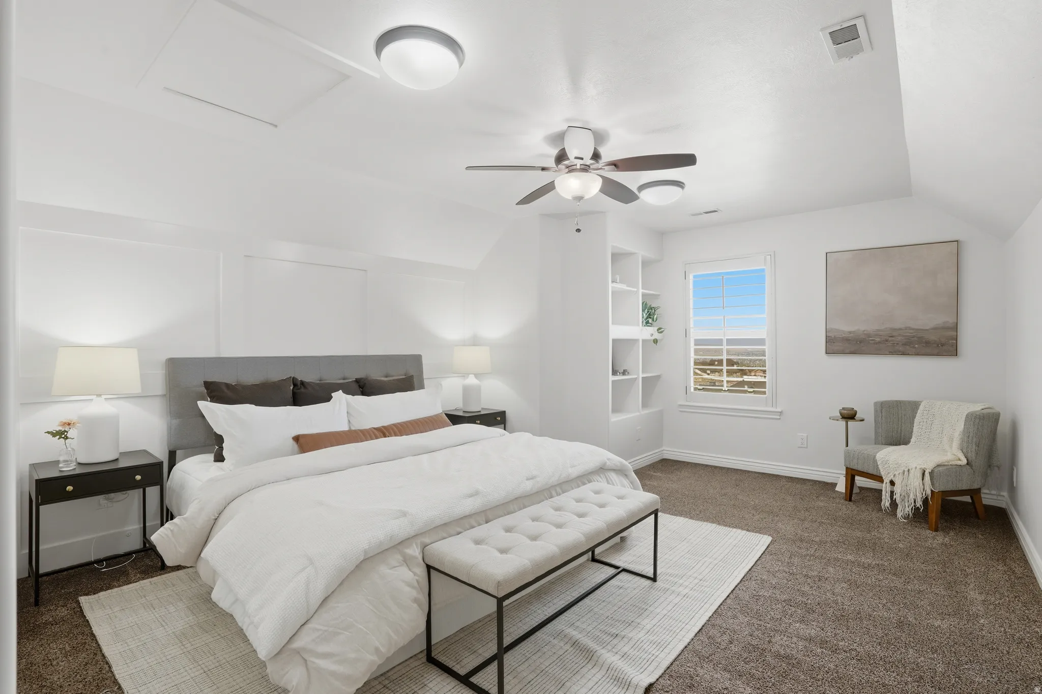 Bedroom with dark carpet, vaulted ceiling, and a ceiling fan