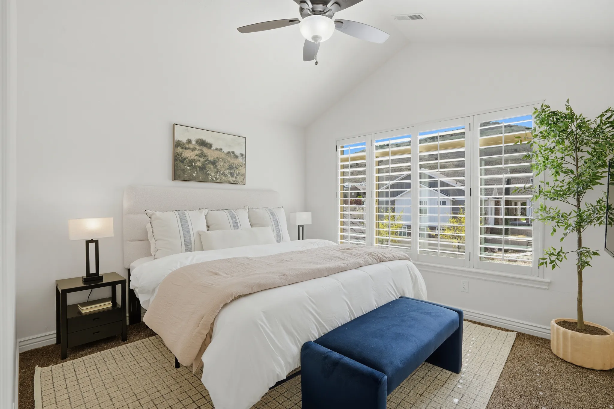 Bedroom with lofted ceiling, carpet, and a ceiling fan