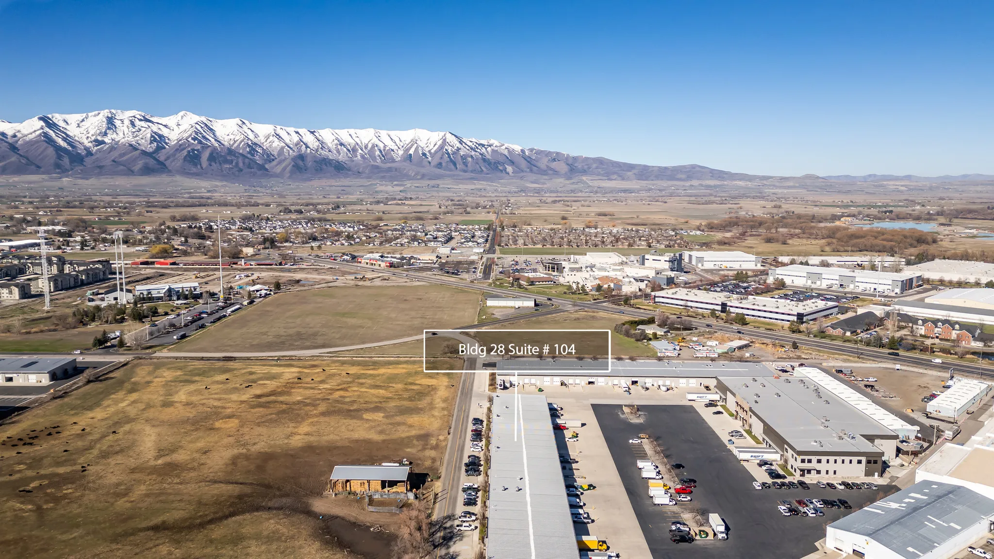 Drone / aerial view of a mountain backdrop and an industrial area