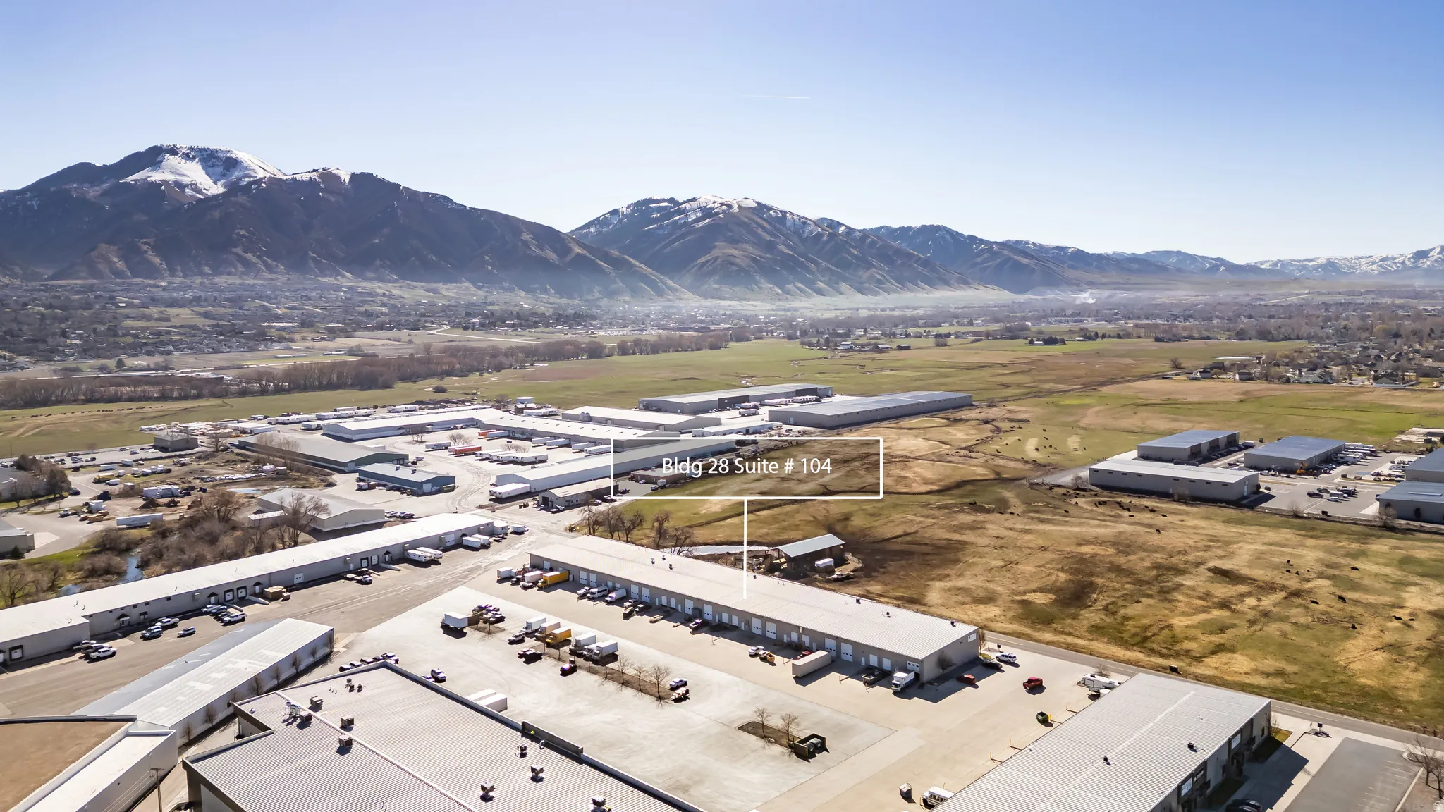 Bird's eye view of industrial structures and a mountain backdrop