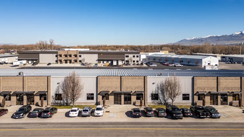 View of commercial property featuring uncovered parking and a mountain view