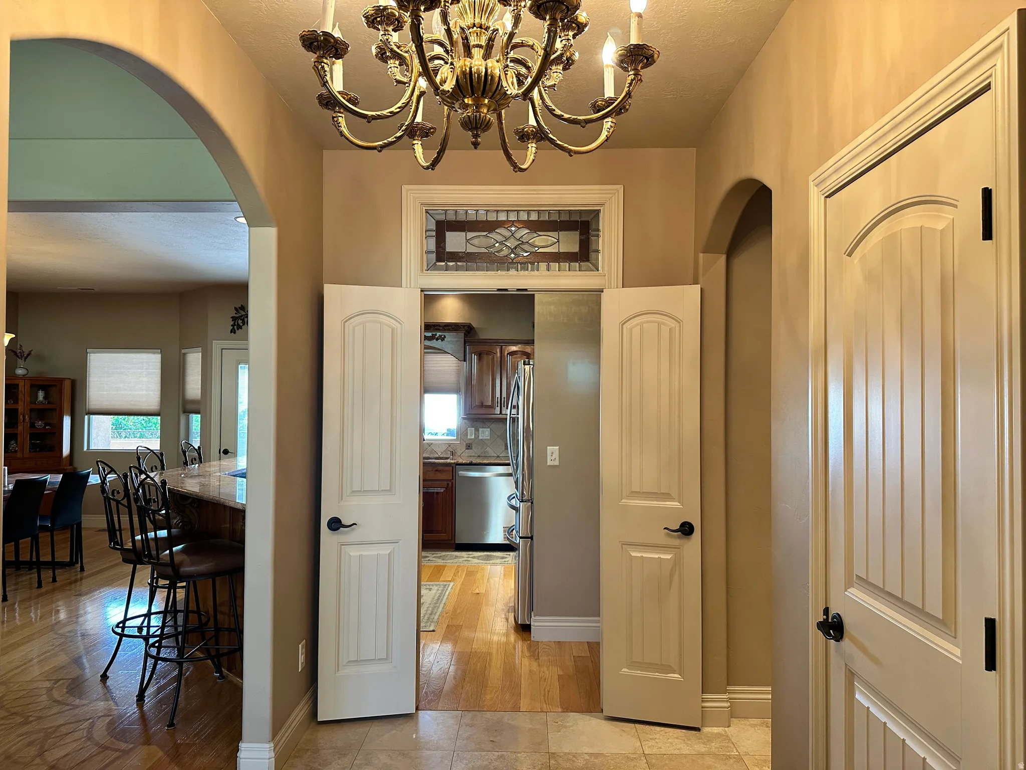 Entry with stain glass transom above entry to kitchen