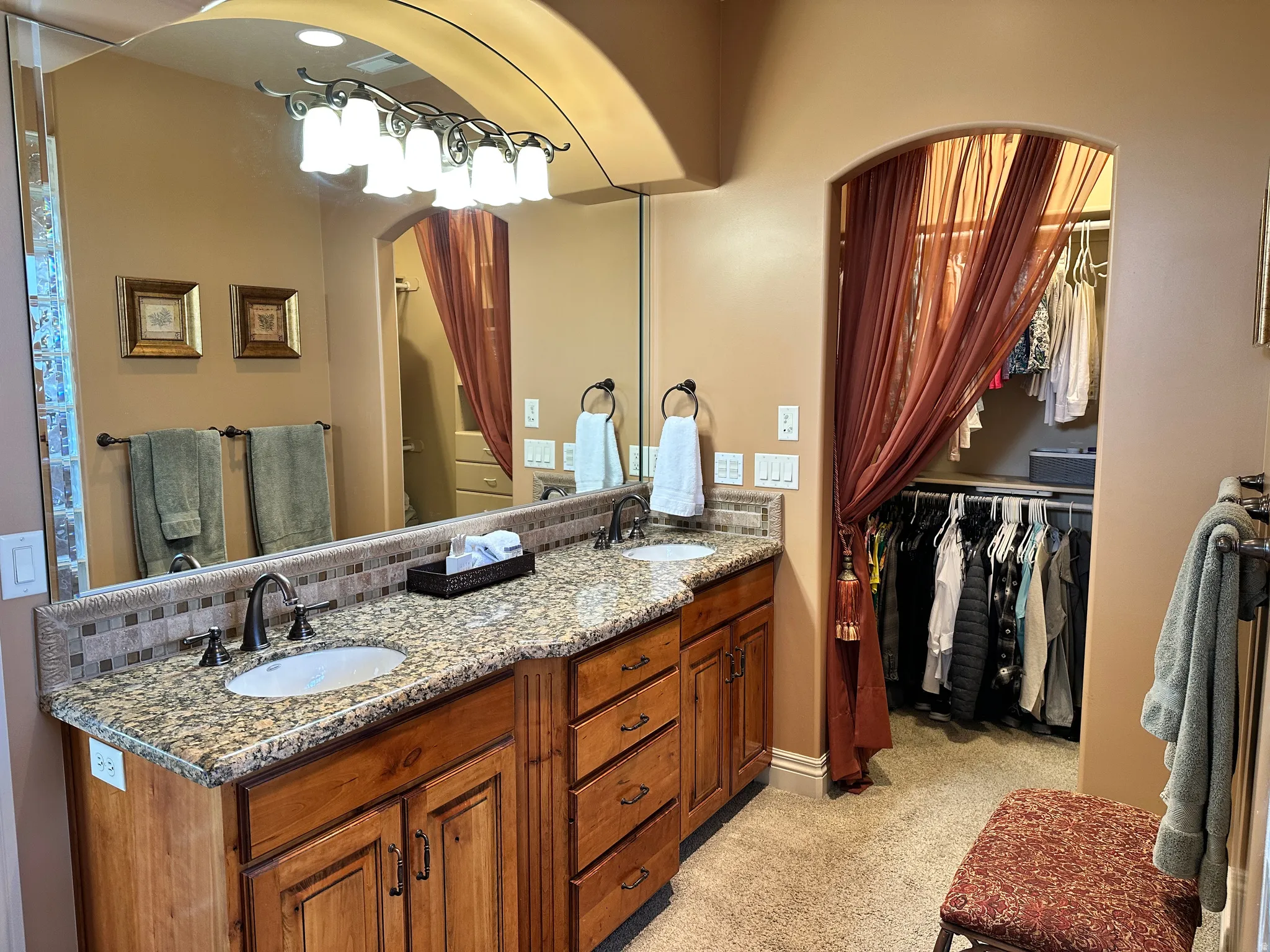 Primary bath with double vanity and a walk in closet