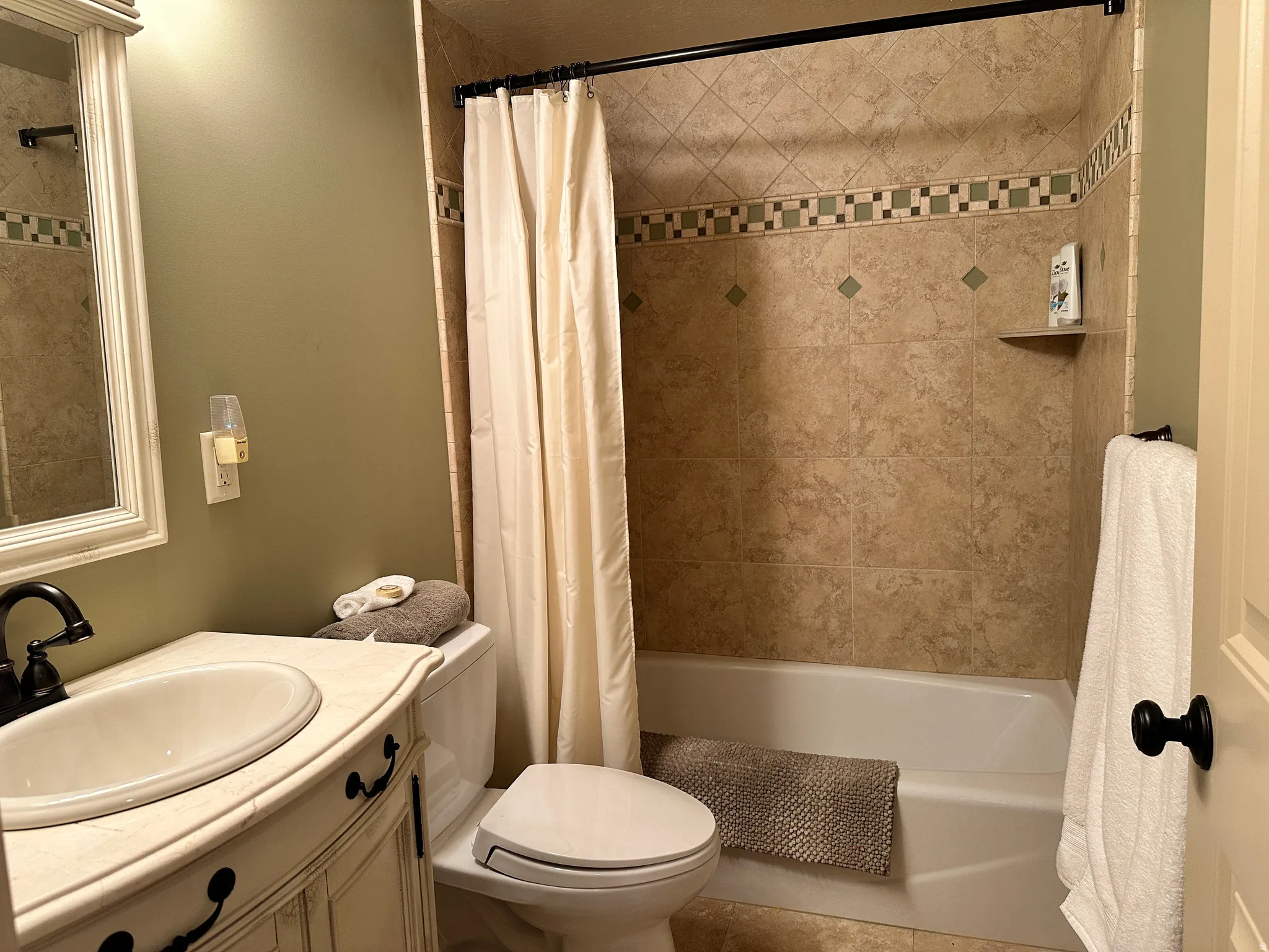 Bathroom featuring vanity and shower / bath combo