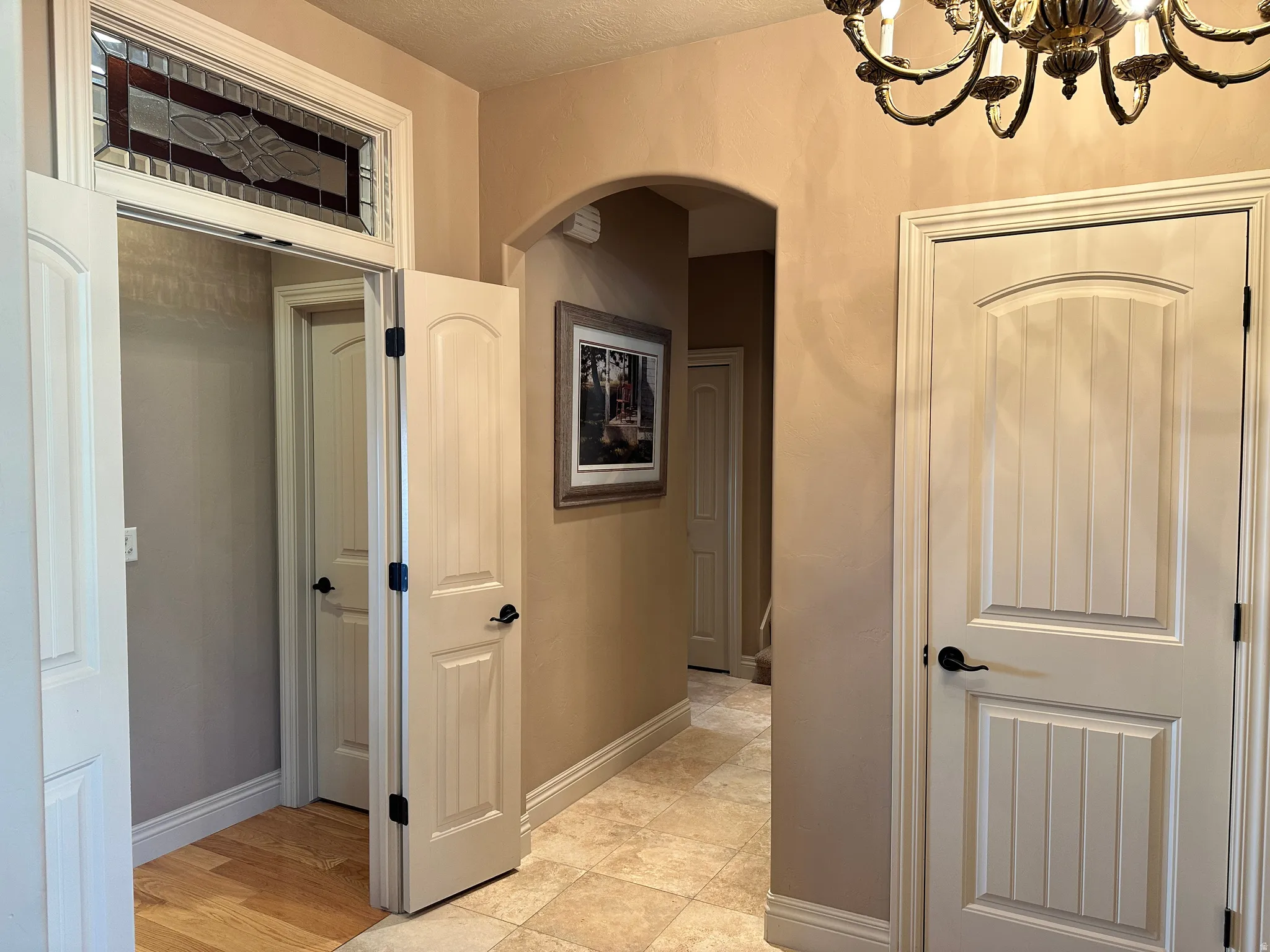 Hallway with arched walkways to office and additional bedroom