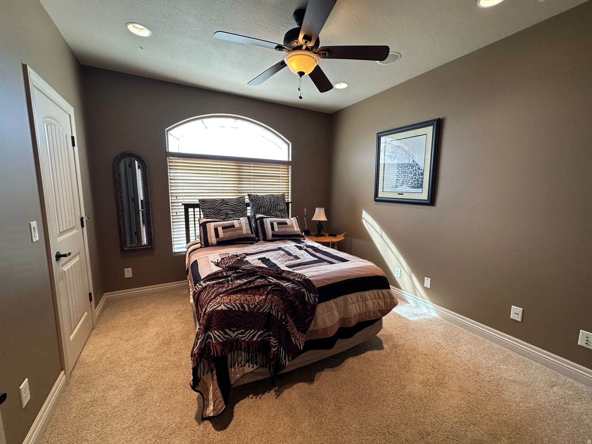 Bedroom with ceiling fan and views of Willard Bay