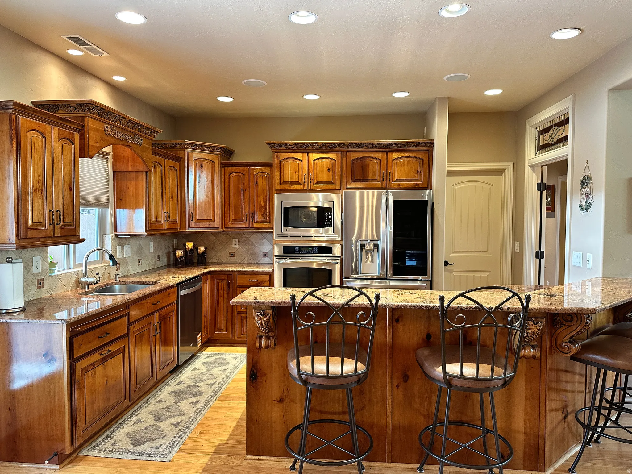 Kitchen has good lighting and bar for casual sitting