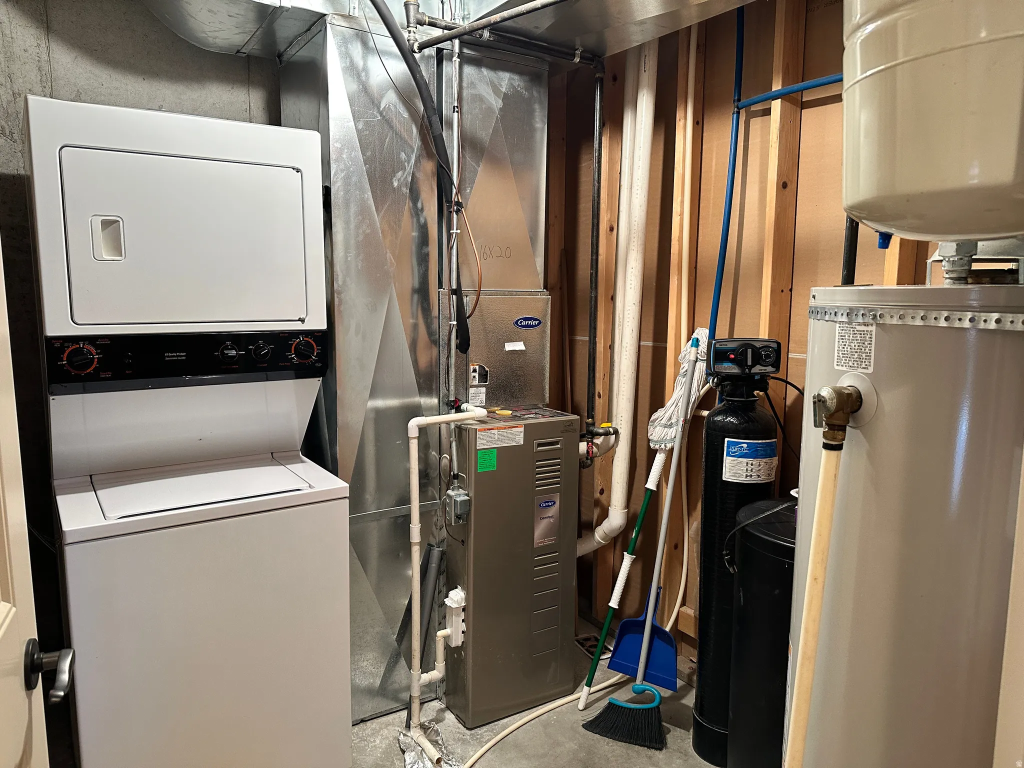 Utilities with stacked washer/dryer showing second laundry facility