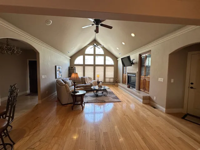 Great room with wood flooring, gas fireplace and vaulted ceiling