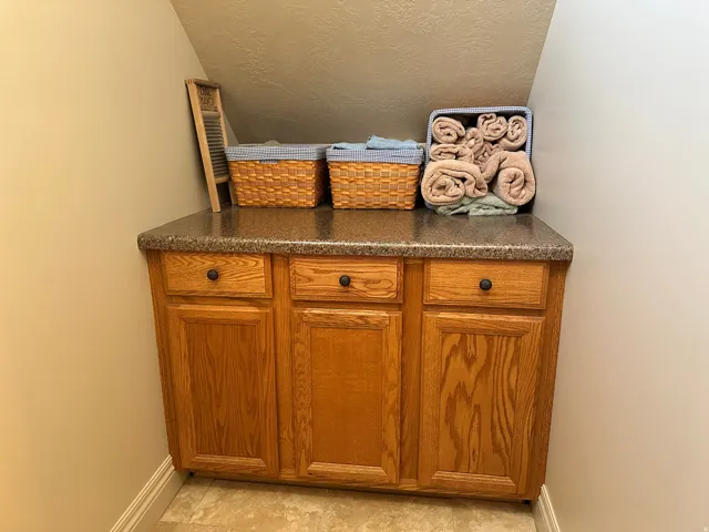 Folding table and cupboards in room adjacent to the laundry