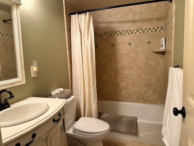 Bathroom featuring vanity and shower / bath combo