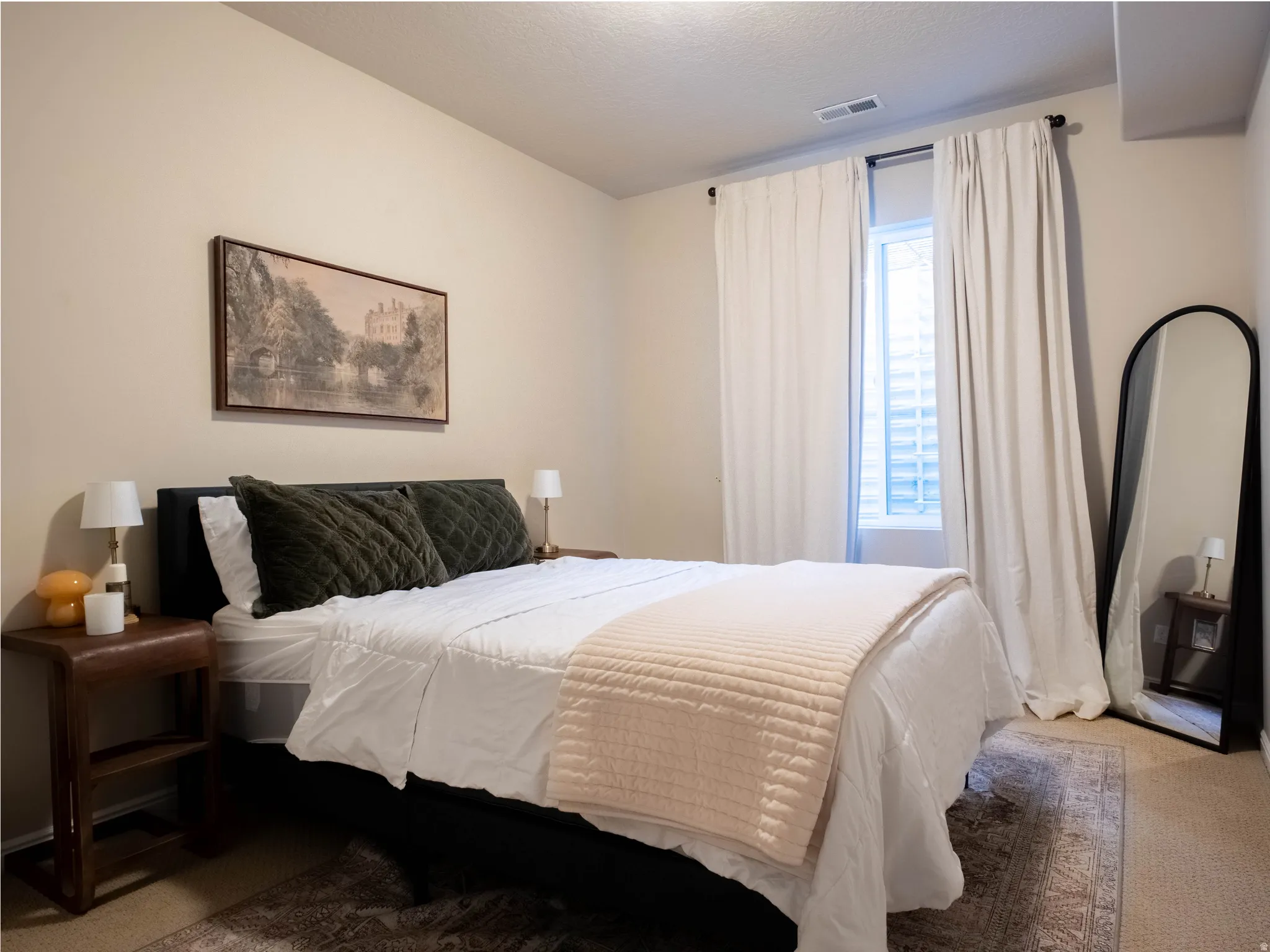 Bedroom featuring carpet and a textured ceiling