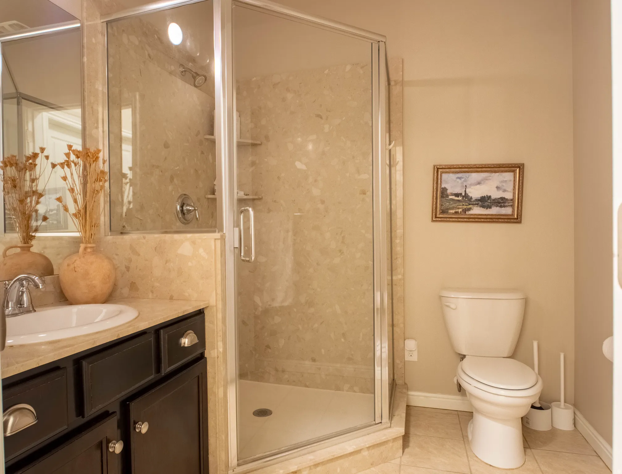 Full bath with vanity, a shower stall, and light tile patterned flooring