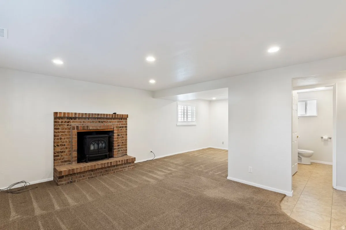 Unfurnished living room featuring carpet flooring and recessed lighting