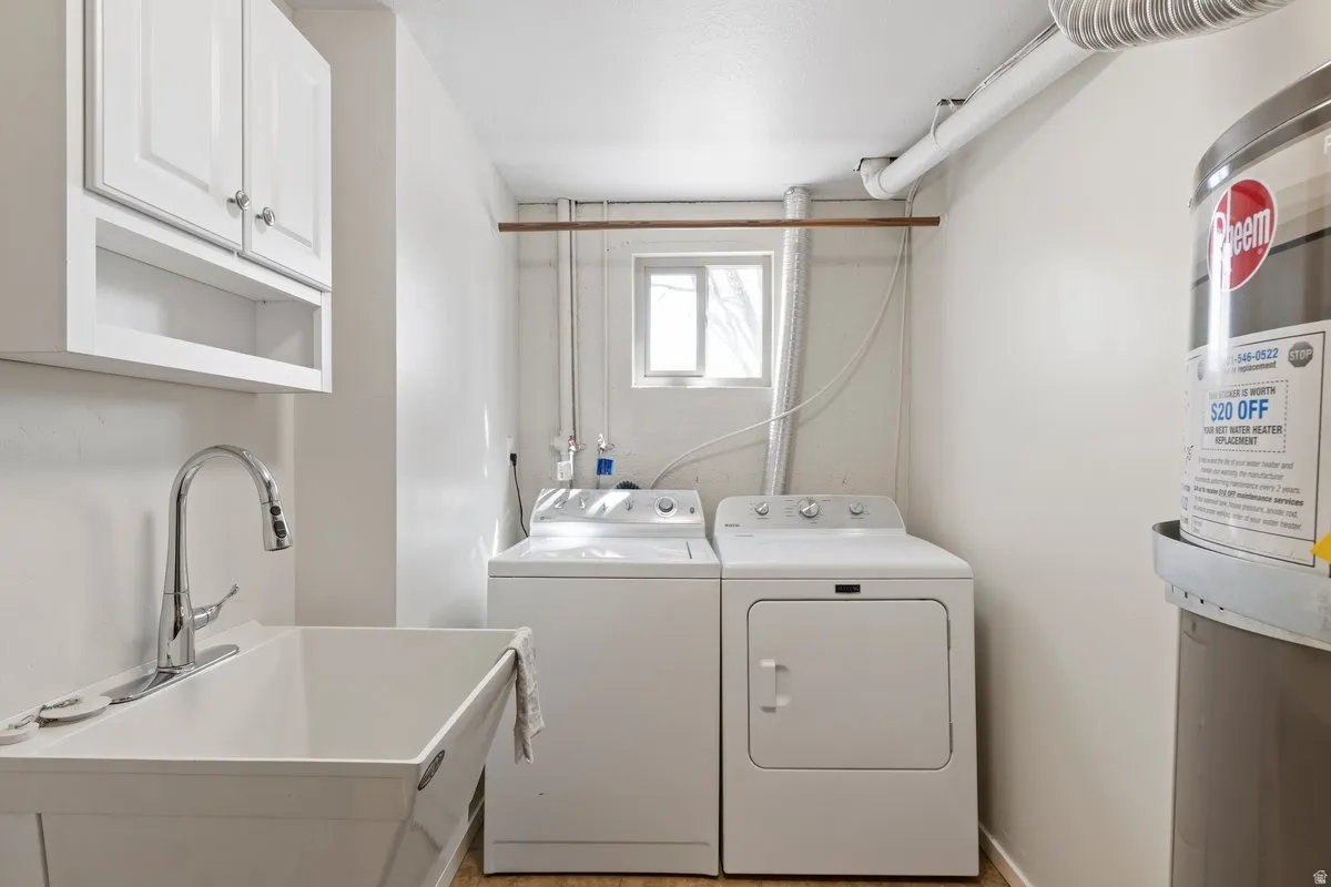 Laundry area with washer and clothes dryer and cabinet space