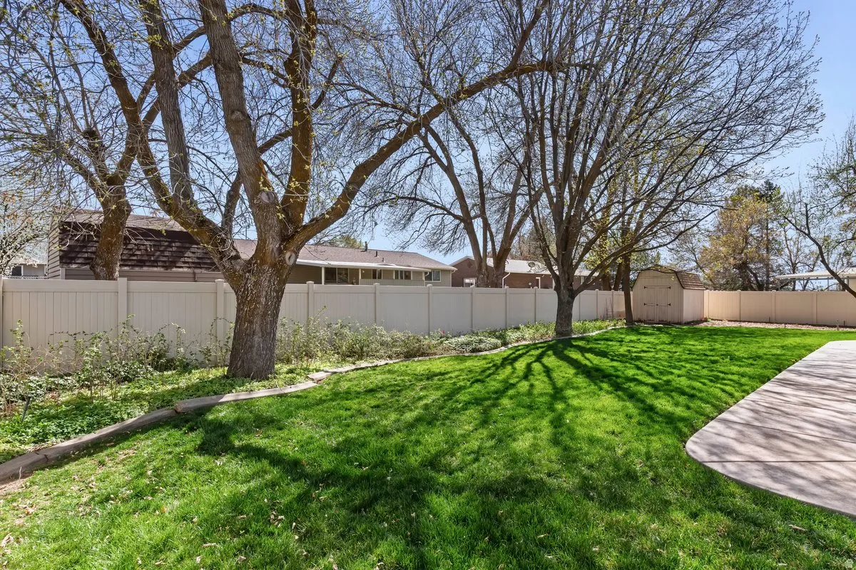 Fenced backyard with a storage shed