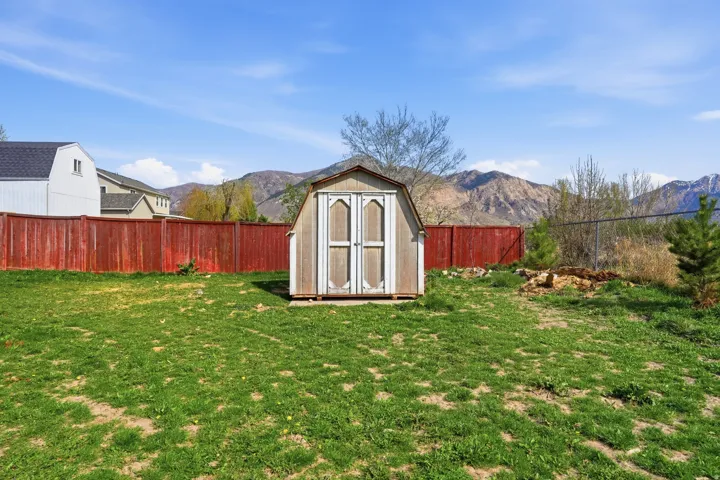 View of shed featuring a mountain view and a fenced backyard