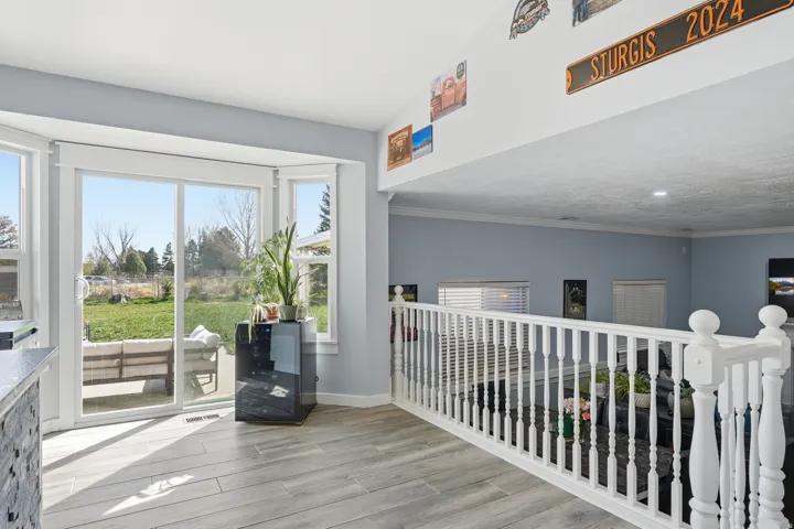 Corridor featuring light wood-style floors and crown molding