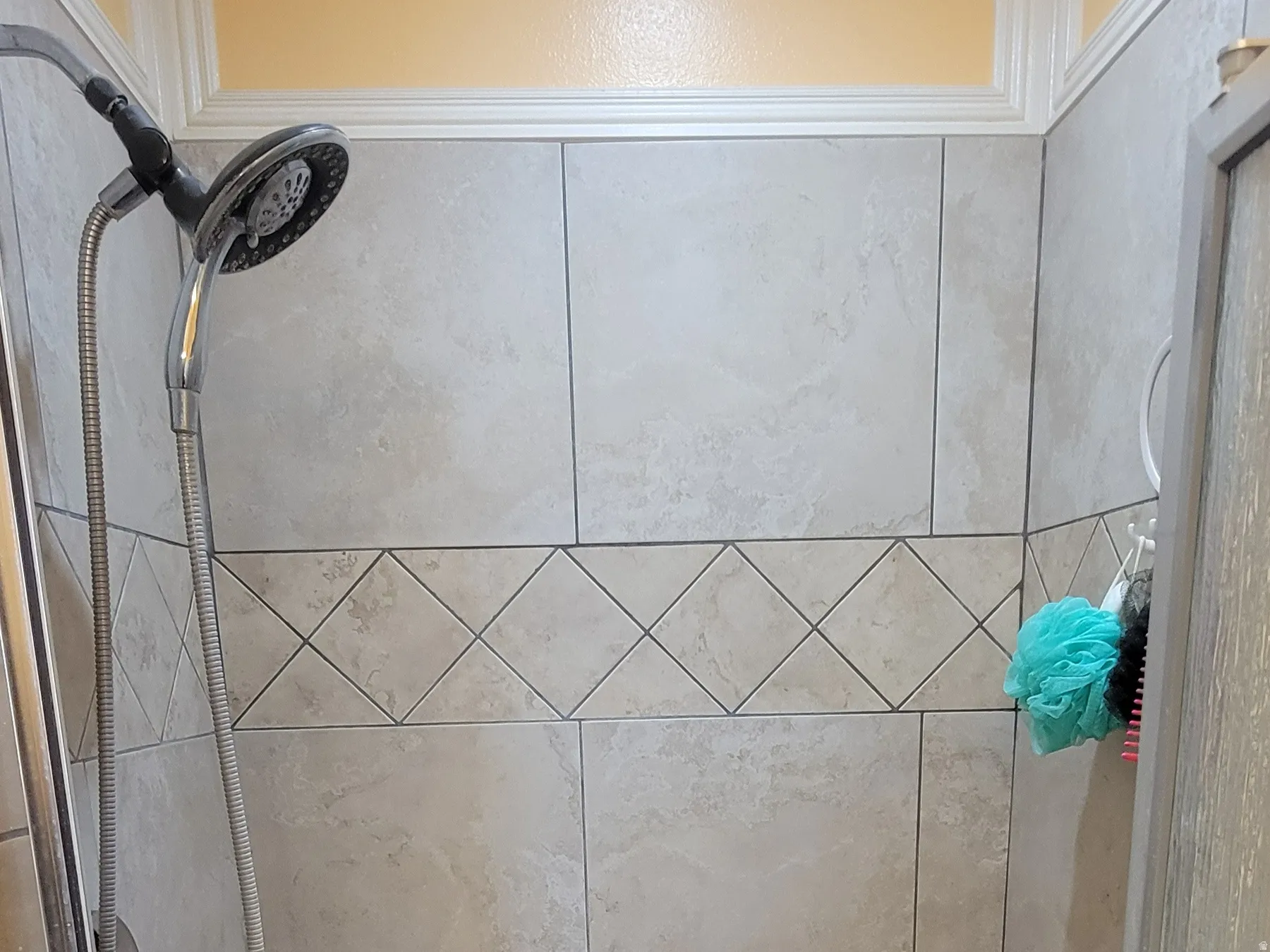 Bathroom with a stall shower and crown molding