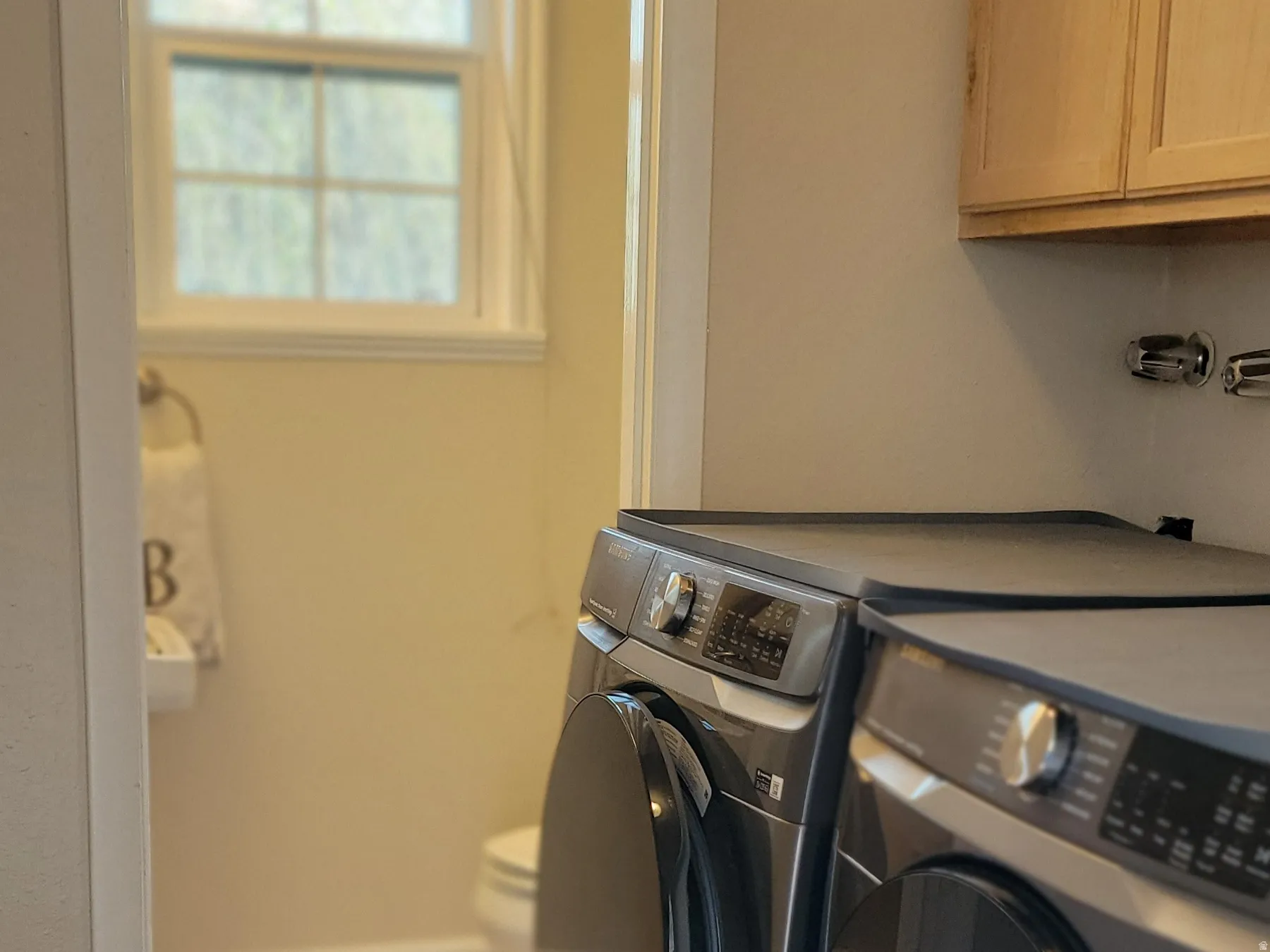 Laundry room featuring light tile patterned floors and washer and dryer
