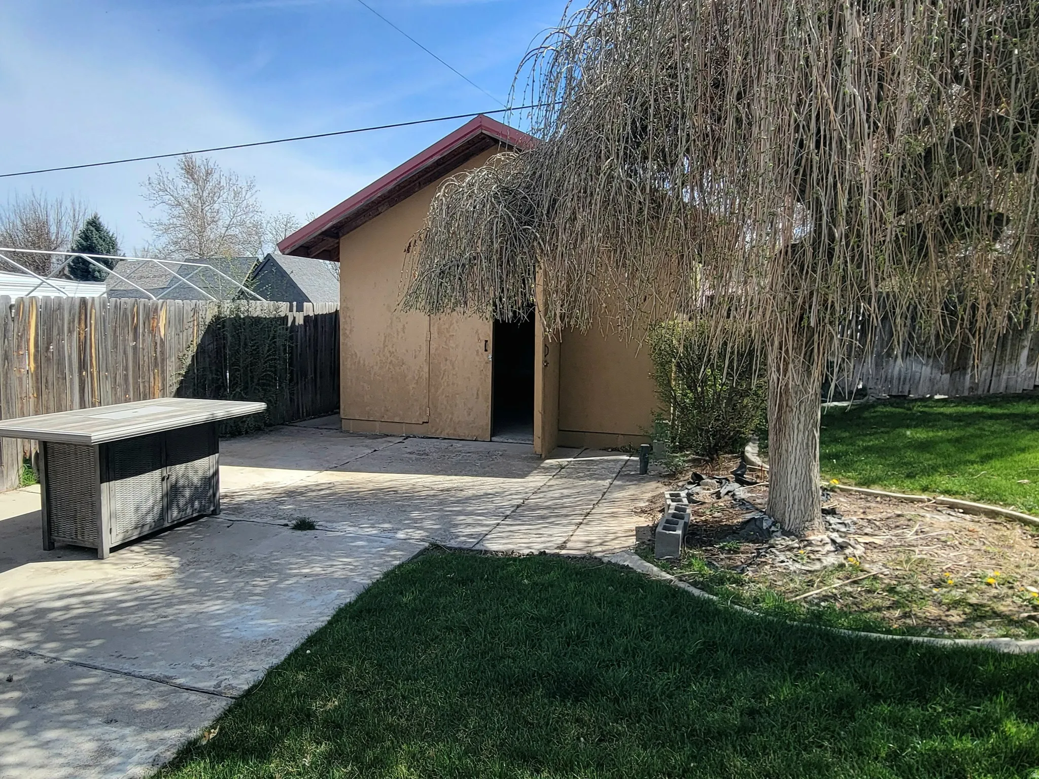 Fenced backyard with a patio