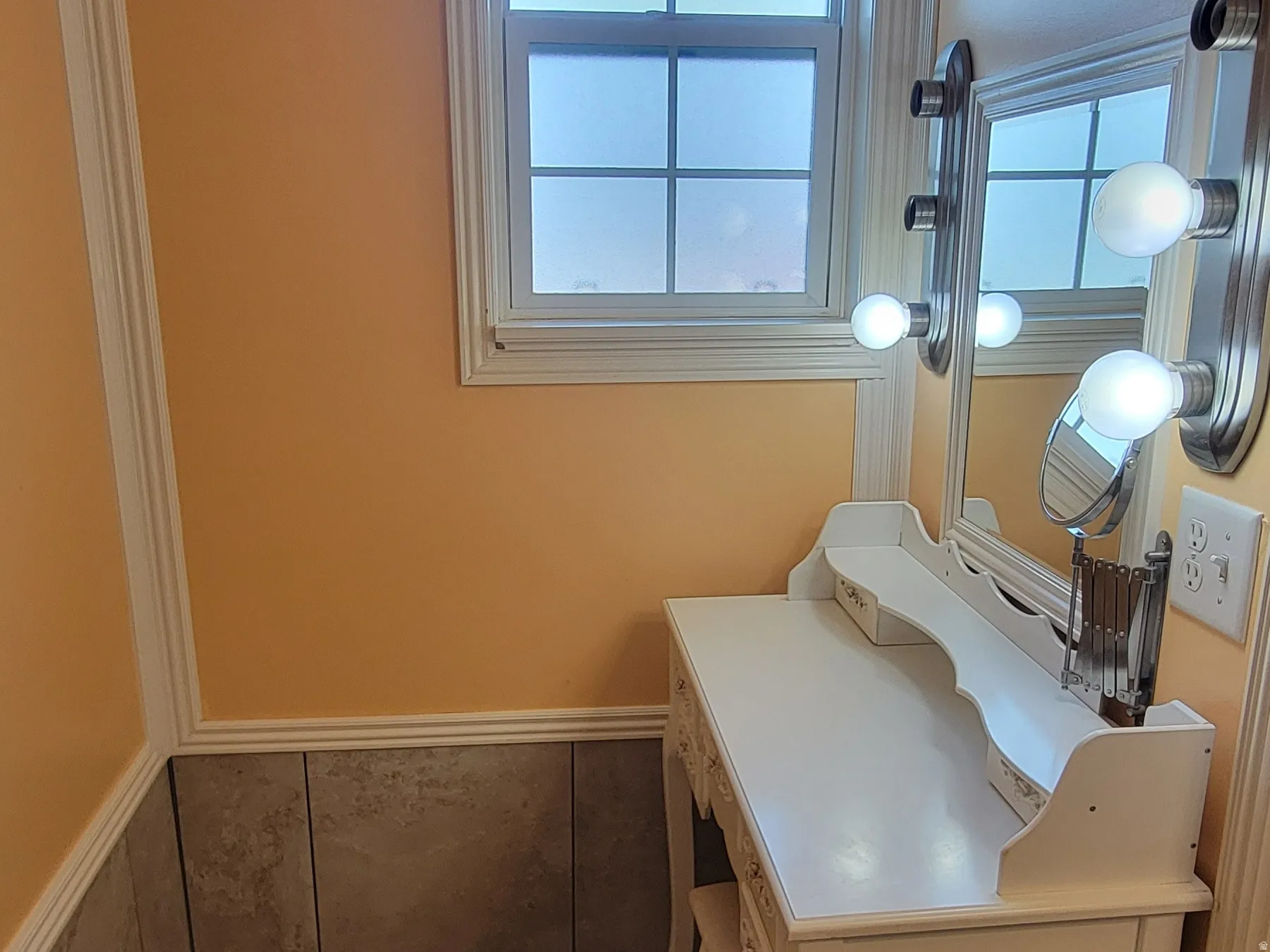 Bathroom with light tile patterned flooring, crown molding, and plenty of natural light