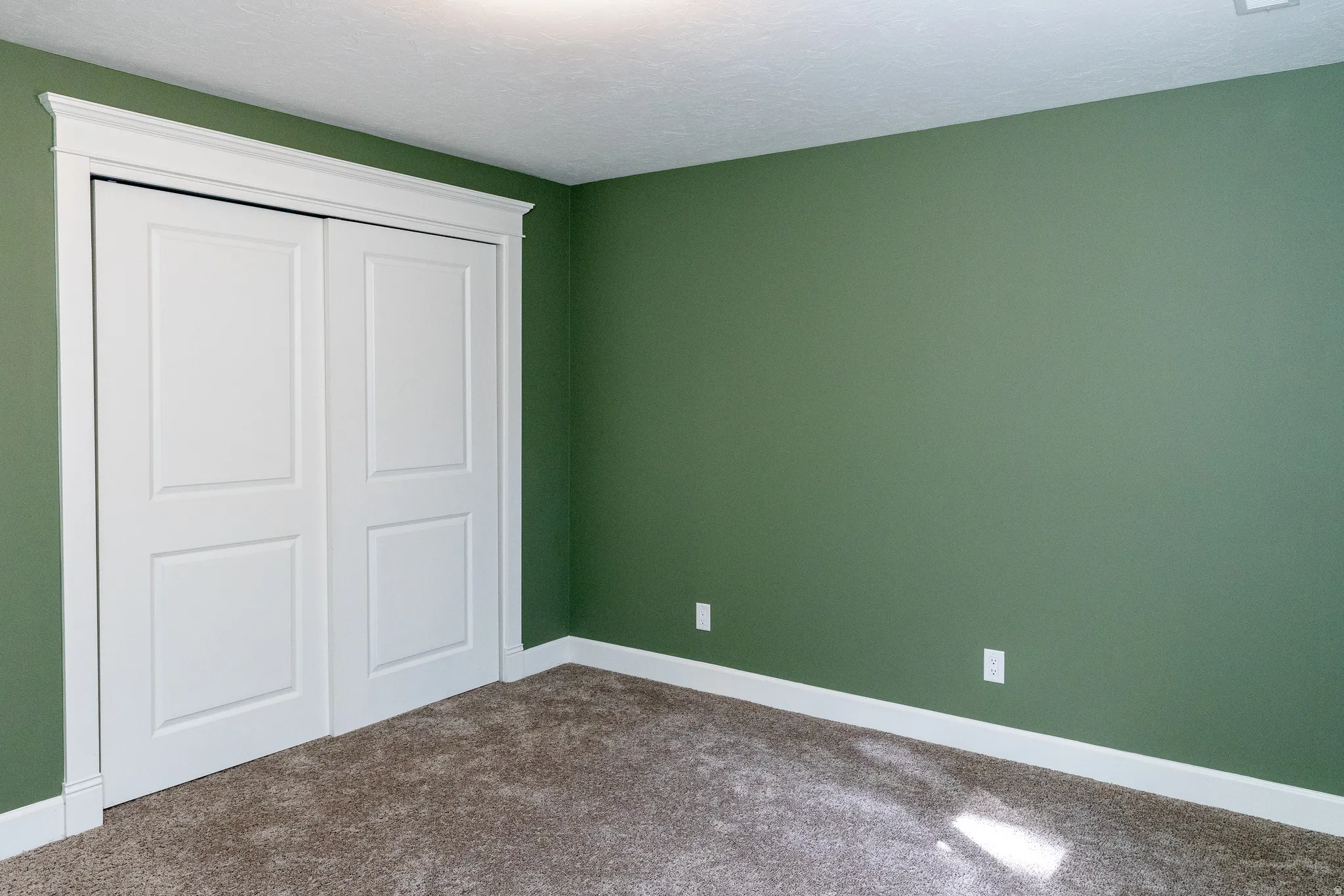 Unfurnished bedroom featuring carpet floors, a closet, and a textured ceiling