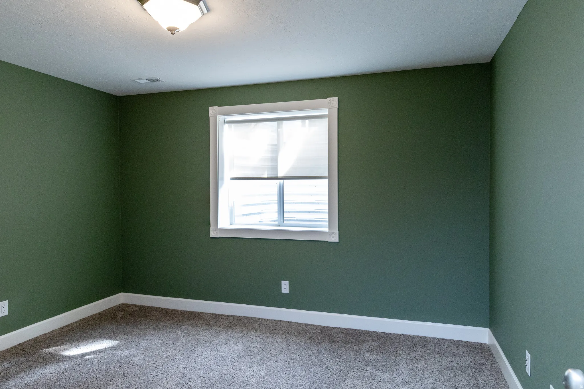 Spare room featuring carpet flooring