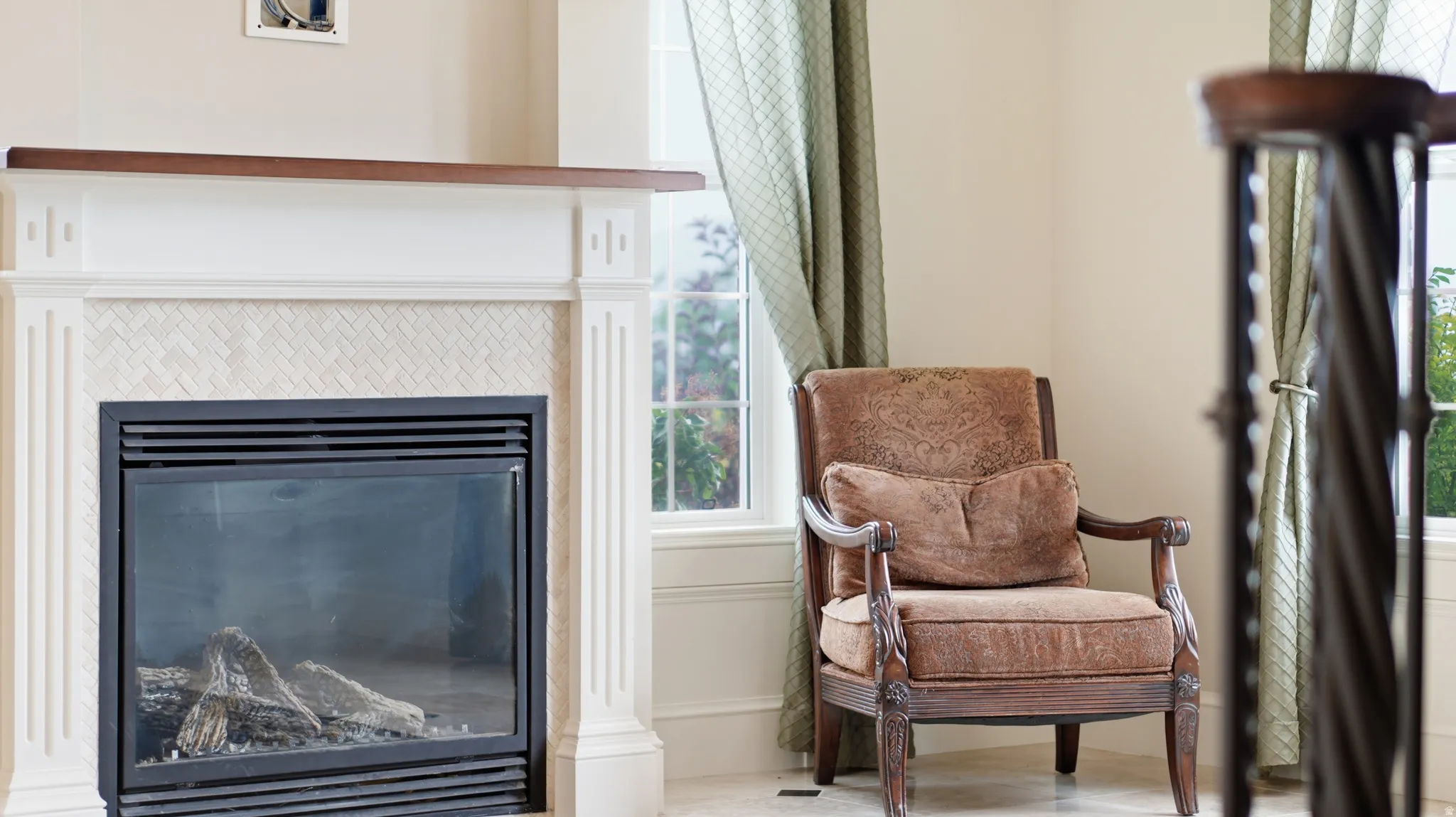Fireplace with a wood-finish mantel and decorative tile surround