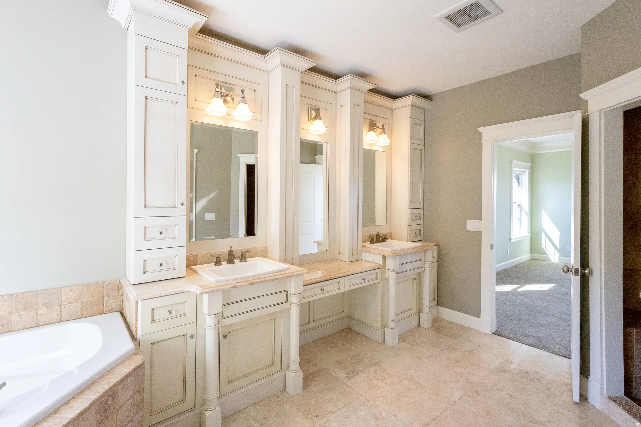 Bathroom featuring vanity, a garden tub, and crown molding