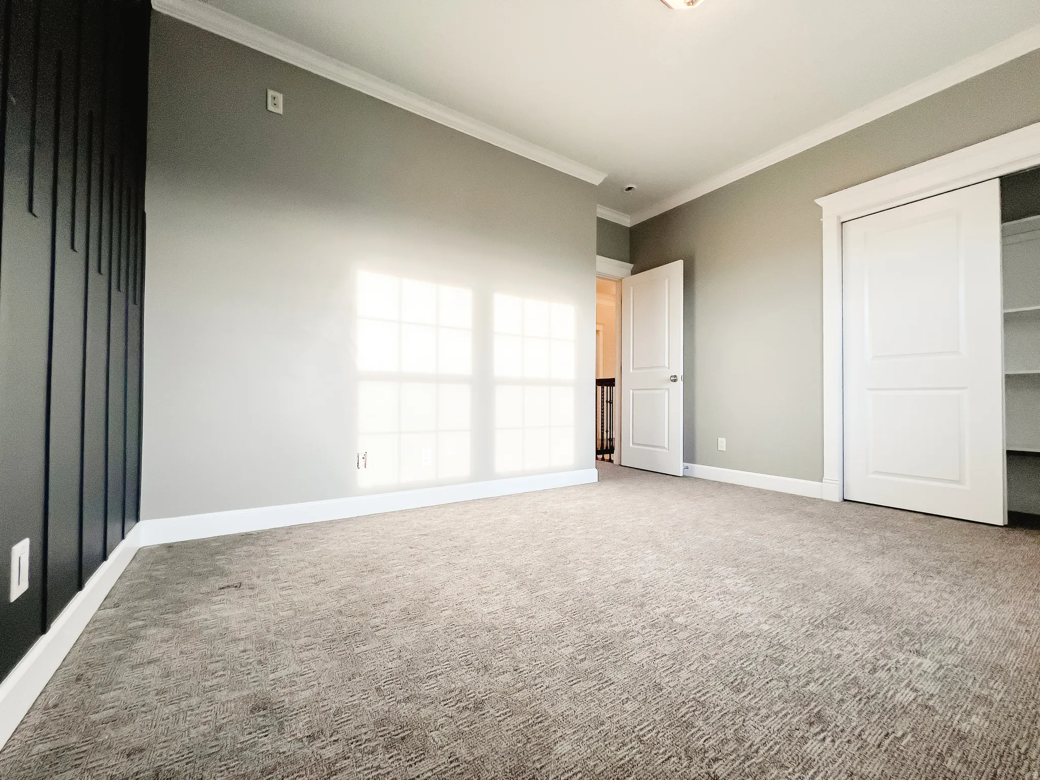 bedroom featuring carpet floors, crown molding, and a closet