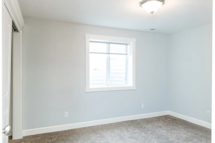 Unfurnished bedroom featuring a closet and carpet floors