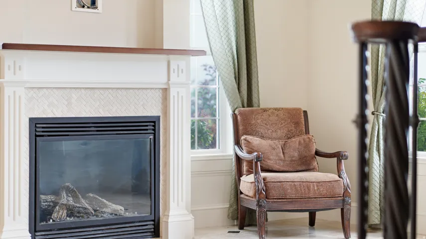 Fireplace with a wood-finish mantel and decorative tile surround