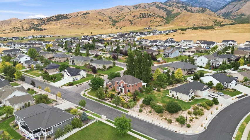 Residential neighborhood with mature landscaping and mountain backdrop