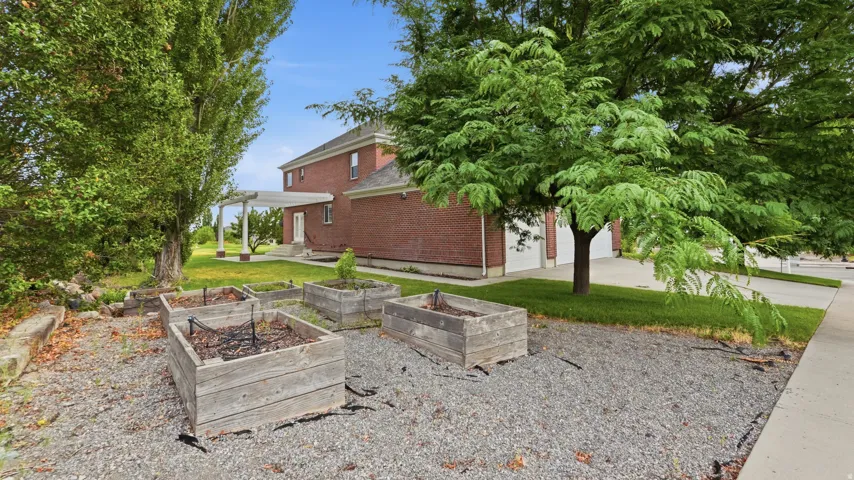 Brick exterior with mature landscaping and established shade trees