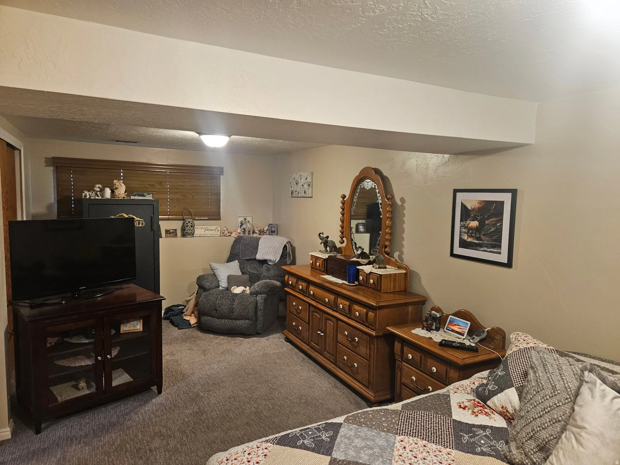 Carpeted bedroom with a textured ceiling
