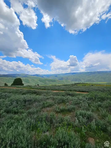 View of mountain background featuring rural landscape