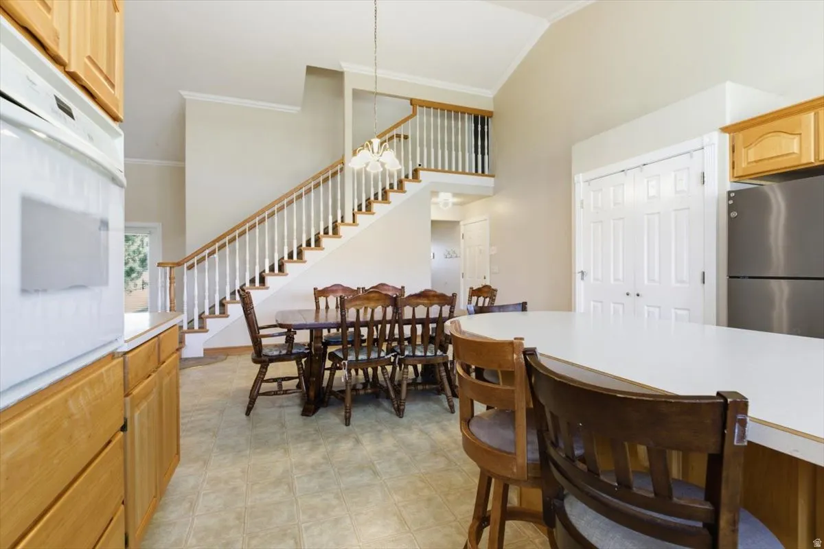 Dining area featuring ornamental molding and a high ceiling
