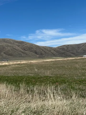 View of mountain background featuring rural landscape
