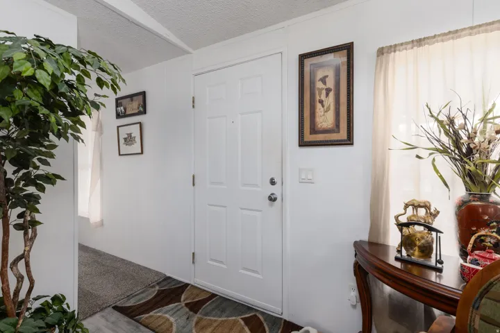 Entrance foyer with a textured ceiling and wood finished floors