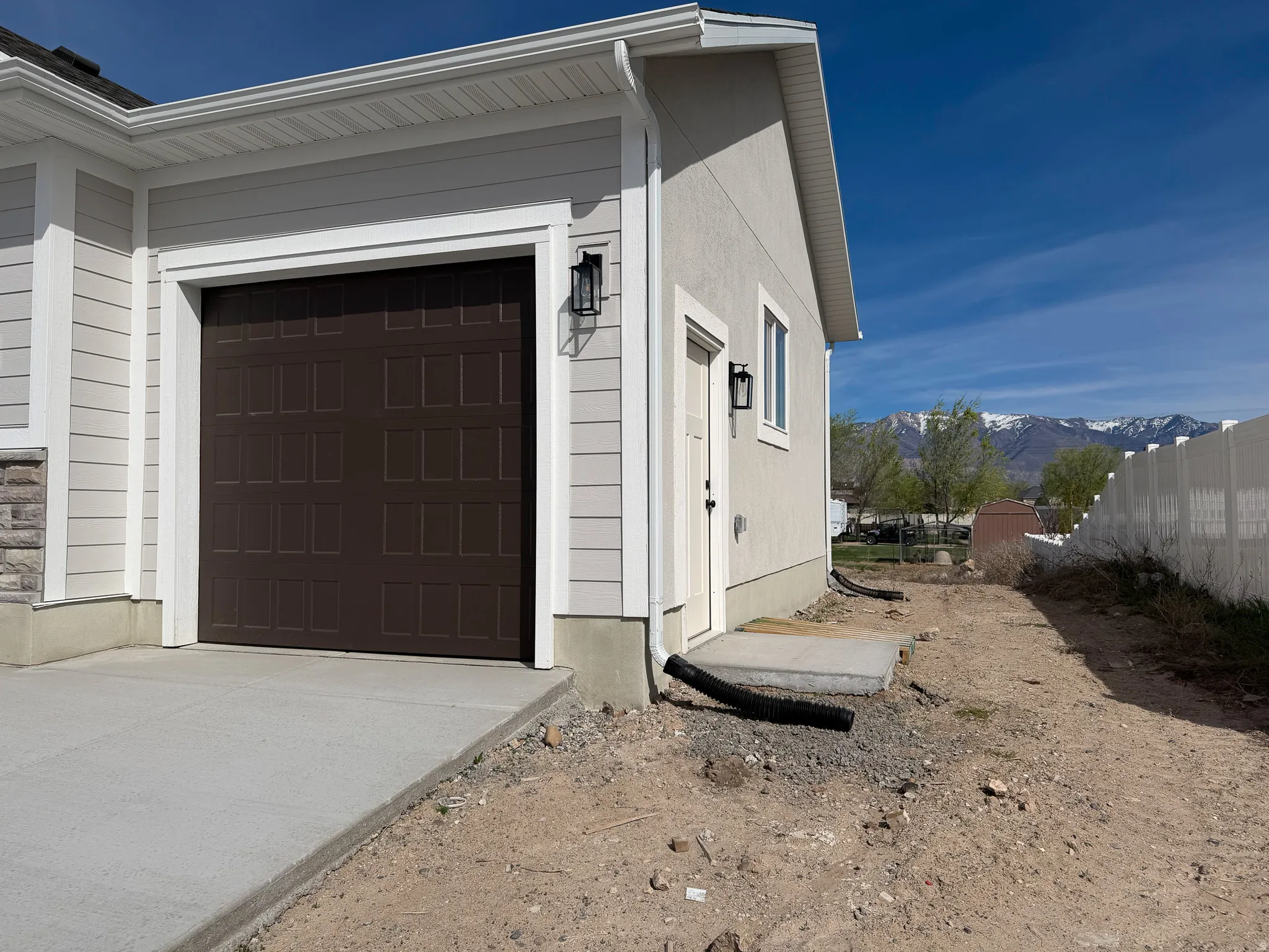 Garage featuring a mountain view and driveway