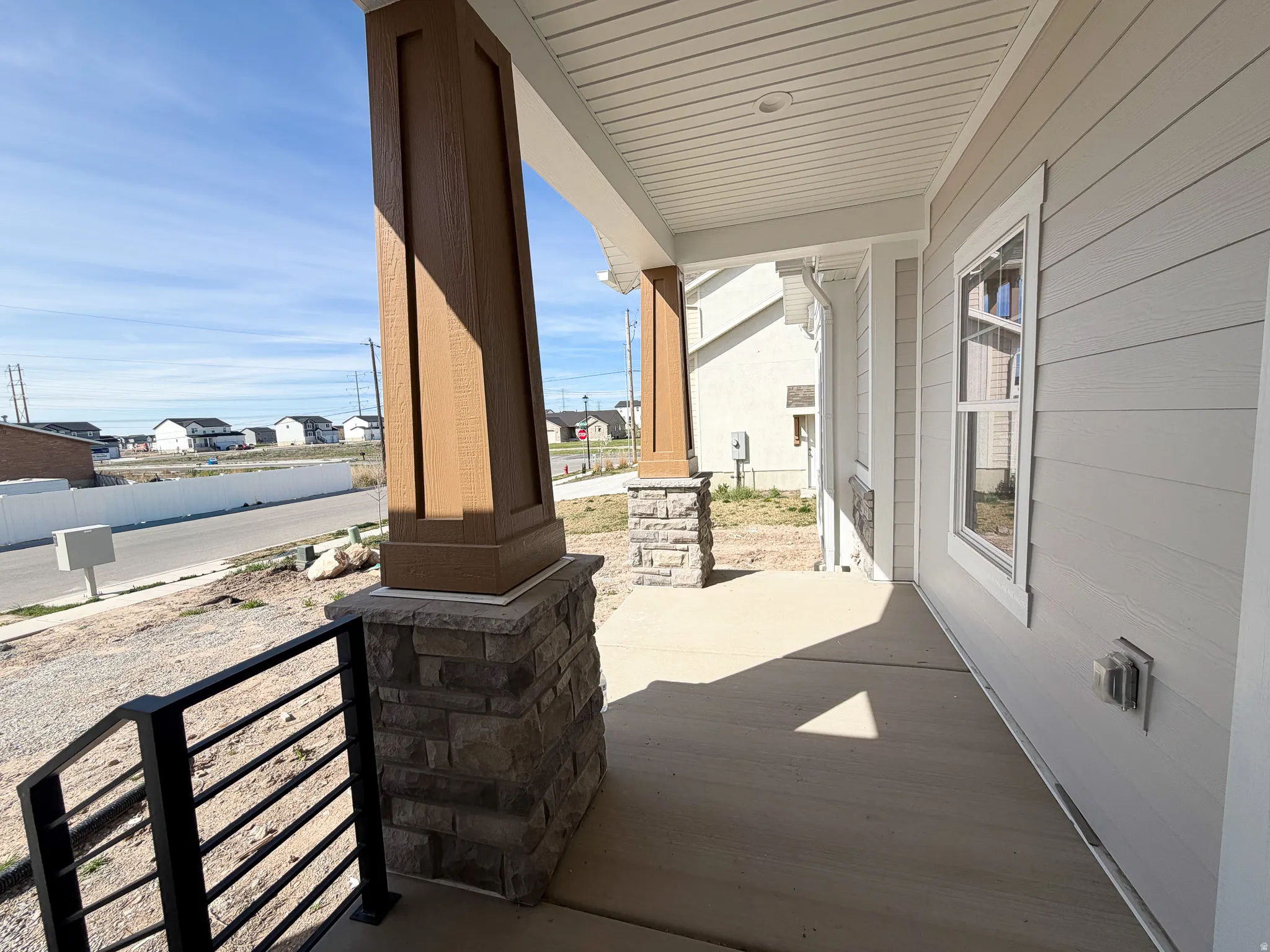 Covered porch featuring a residential view