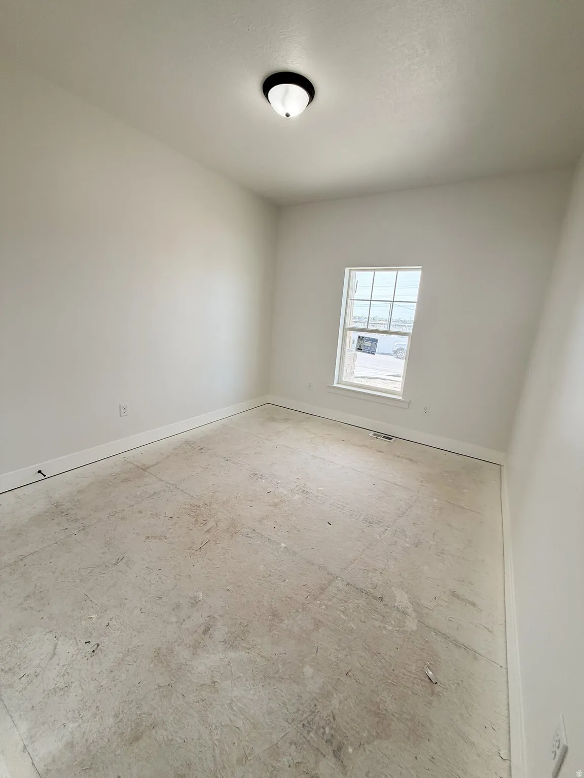 Empty room featuring baseboards