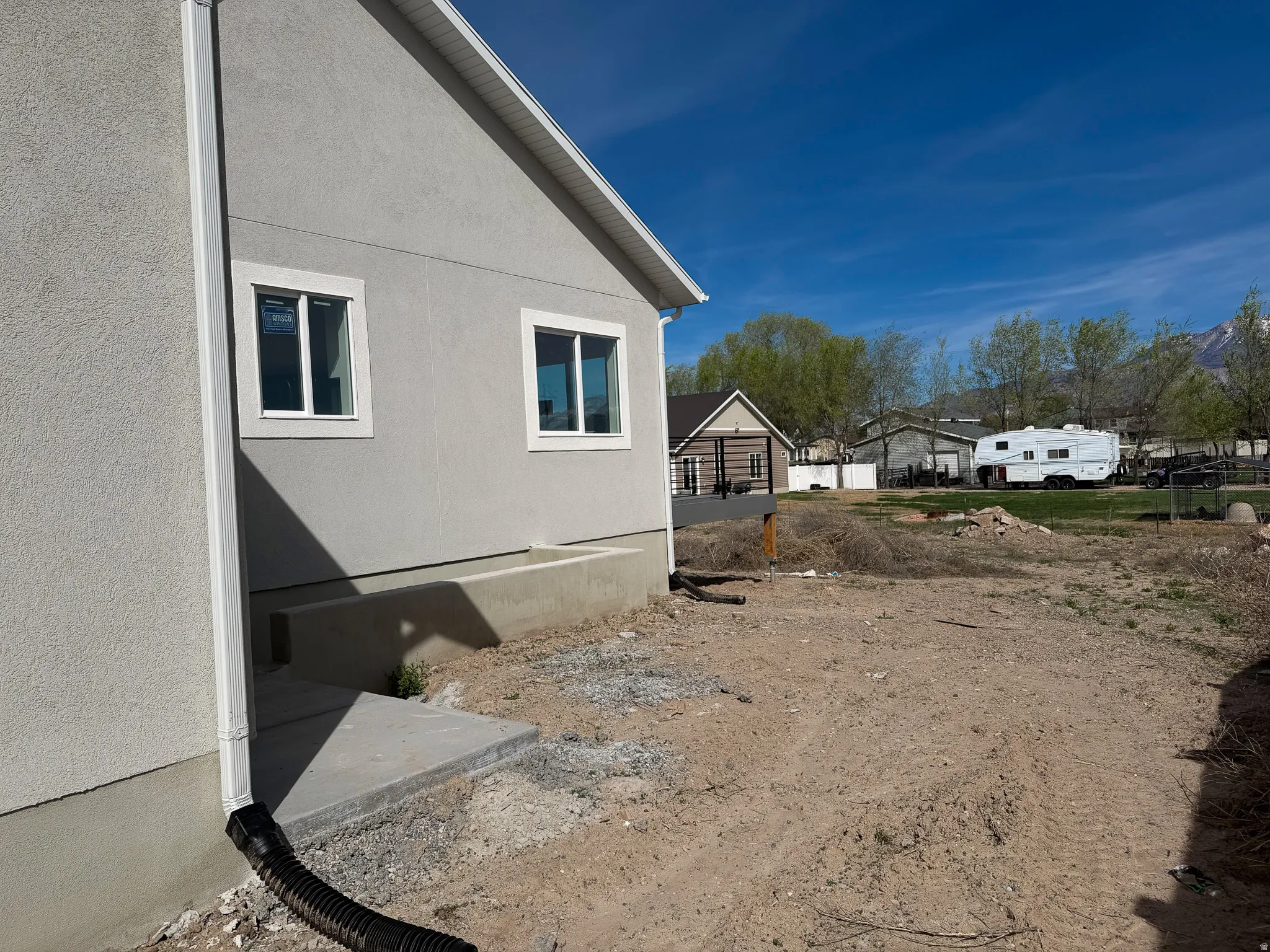 View of side of home with stucco siding