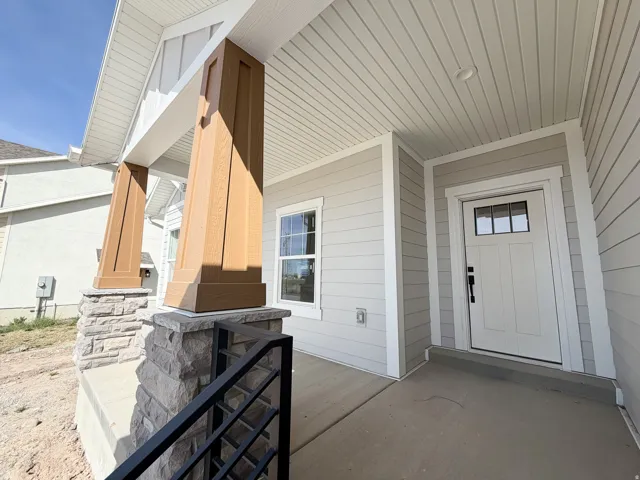 View of exterior entry featuring covered porch