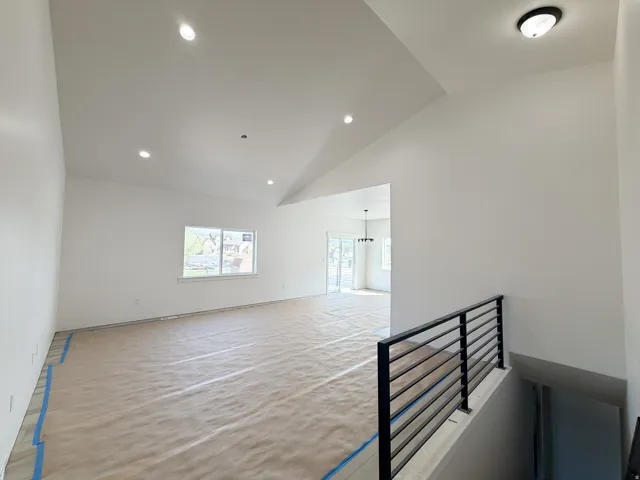 Spare room with vaulted ceiling and recessed lighting