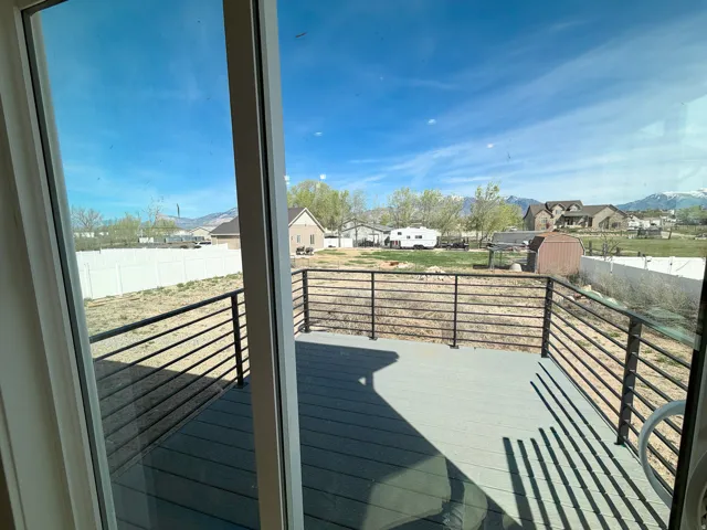 Wooden terrace with a residential view and a storage shed